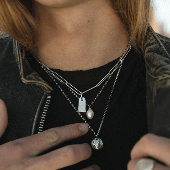 model wearing our gravestone pendant with paper clip chain