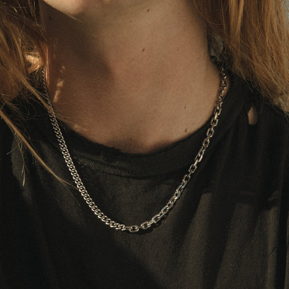 close up shot of our half & half chain necklace being worn by model