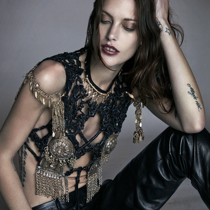 female model wearing our metal moto skin, a custom made brass and deerskin body piece with metallic bra