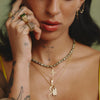 female model wearing our gravestone pendant in gold rolo chain