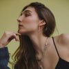 female model's profile wearing our snake stud earrings