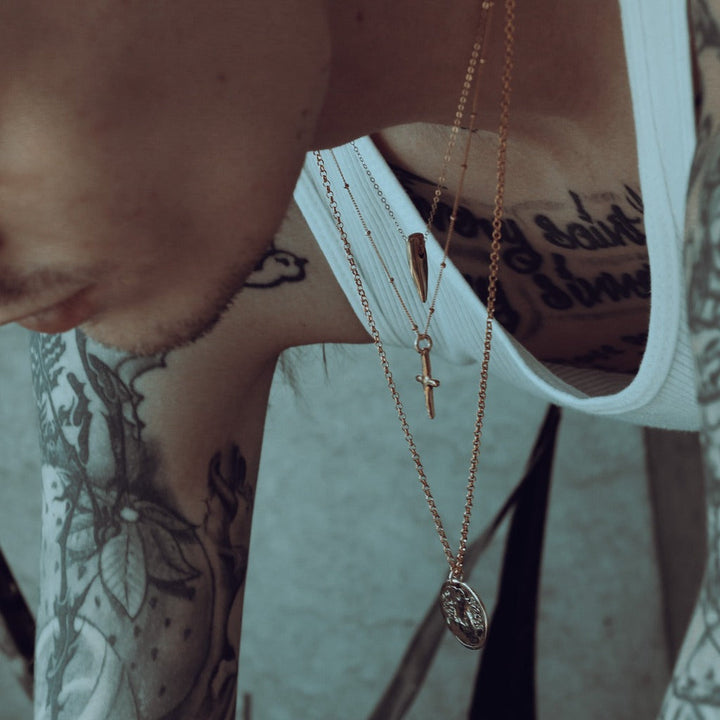 male model wearing our gold spike necklace