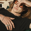 male model laying down, wearing our half & half chain bracelet
