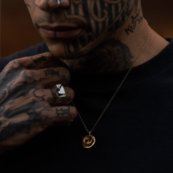 male model wearing our liquid coin pendant