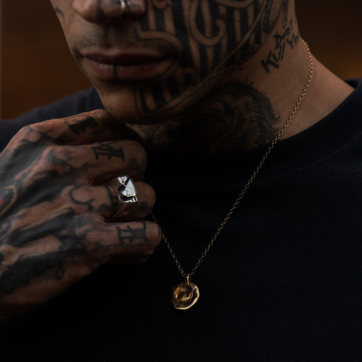 male model wearing our liquid coin pendant