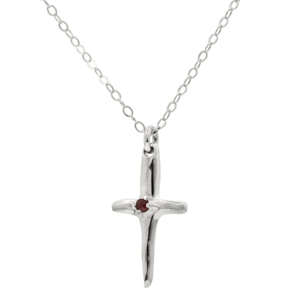 sterling silver cross pendant with red garnet in the center, hanging from silver rolo chain
