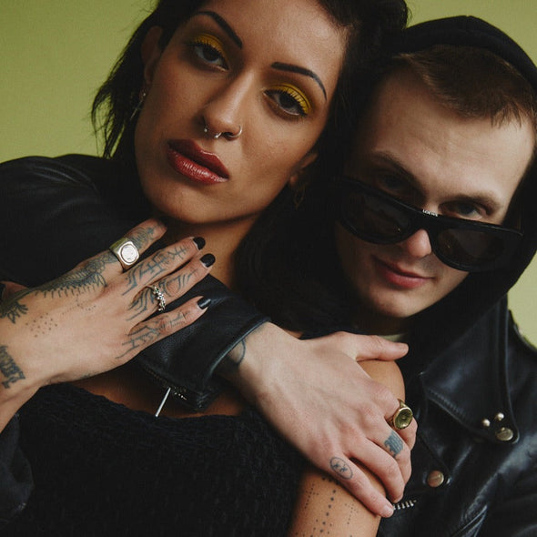 coupple of models in which the female model is wearing our studded green garnet ring