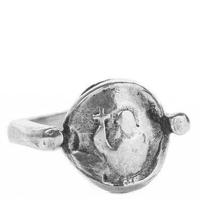 sterling silver signet ring which is a coin with a thin band. The coin has an image of an abstract mother mary with a cross engraved in it. shot on white background