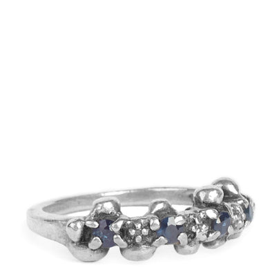 thin gemstone studded ring with four blue sapphires