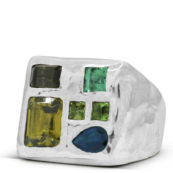 melty surface square signet ring cast in sterling silver with asymmetrically placed gemstones, which include: emerald cut Peridot gemstone, and 3 Green Tourmaline gem, 1 rectangle smokey quartz, and 1 tear drop shaped blue Sapphire.