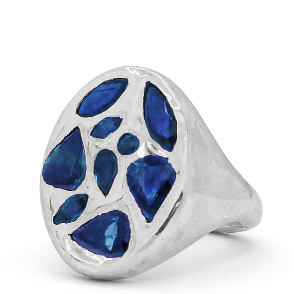 melty surface oval signet cast in Sterling Silver with 9 multi shaped blue Sapphires.