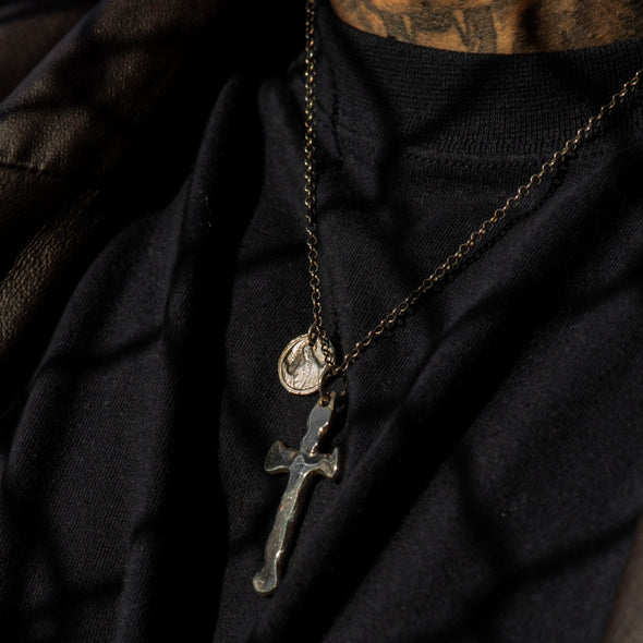 male model wearing our cross and coin necklace