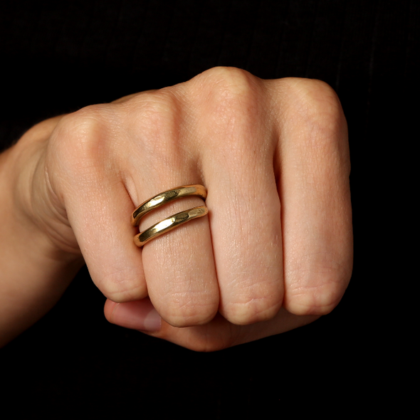 close up shot of fist wearing our loop ring in solid gold