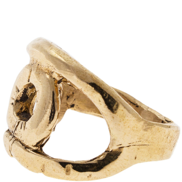 Side view of Handmade recycled Brass ring with a negative space eye design.