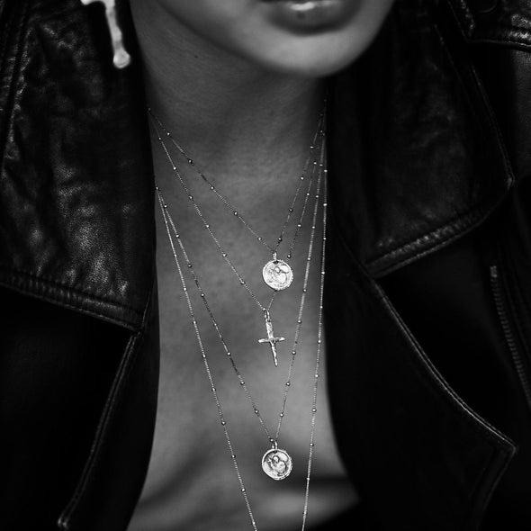 model wearing our holy coin necklace